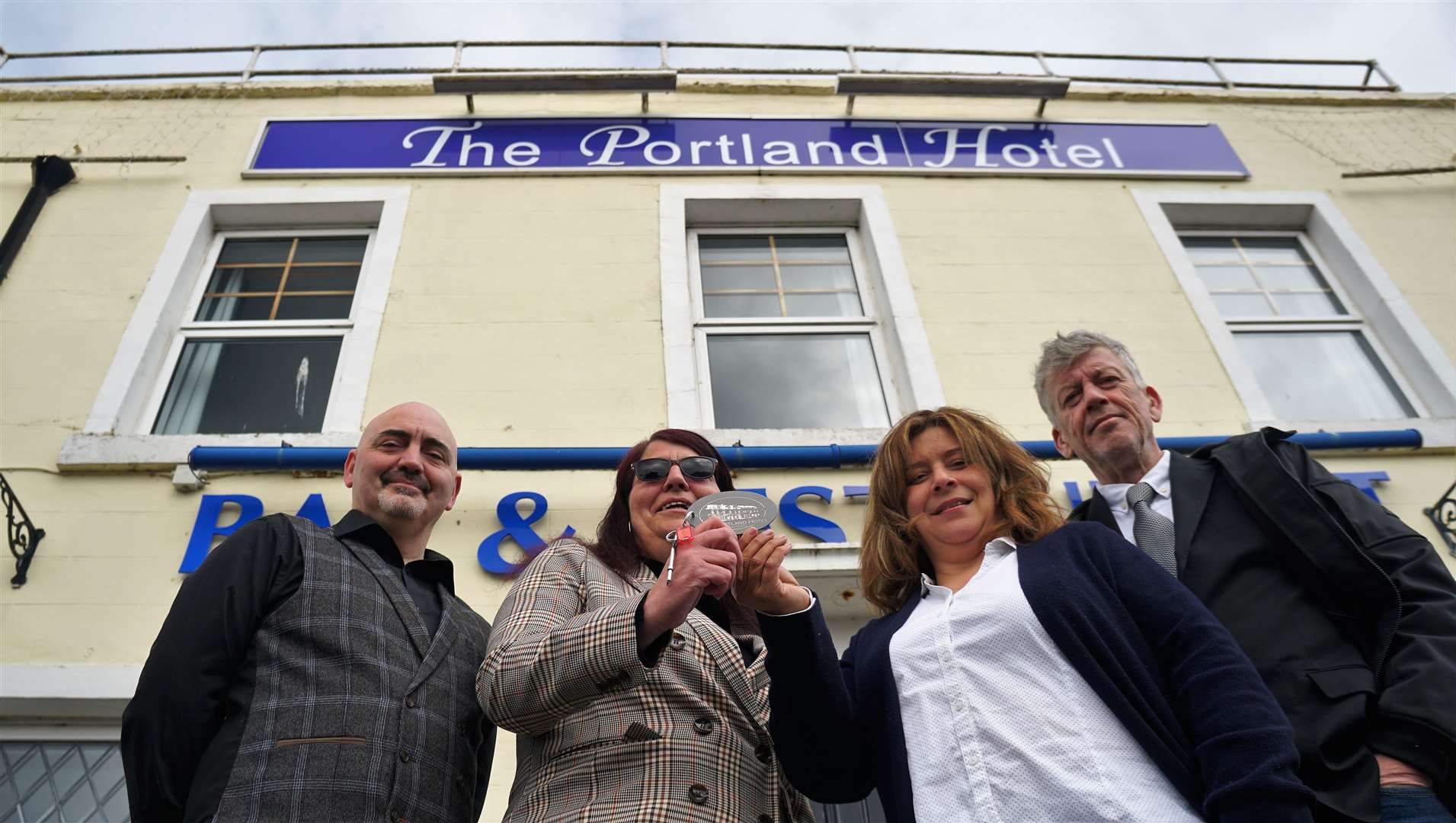 Previous owners of the Portland Hotel Steven Swan and his sister Sharn, at left, hand over the hotel keys to Jeff Harling and his wife Sam Mofttah. Picture: DGS
