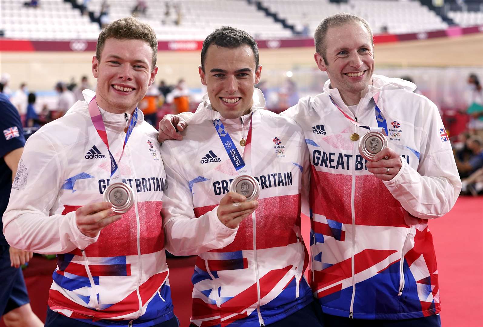 Jack Carlin with Ryan Owens and Jason Kenny after winning silver in the men’s team sprint (Danny Lawson/PA)