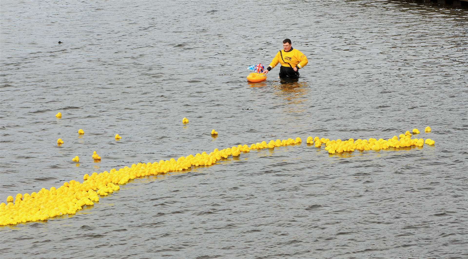 Lifeboat mechanic Johnny Grant supervises some of the 600-plus plastic ducks. Picture: Alan Hendry