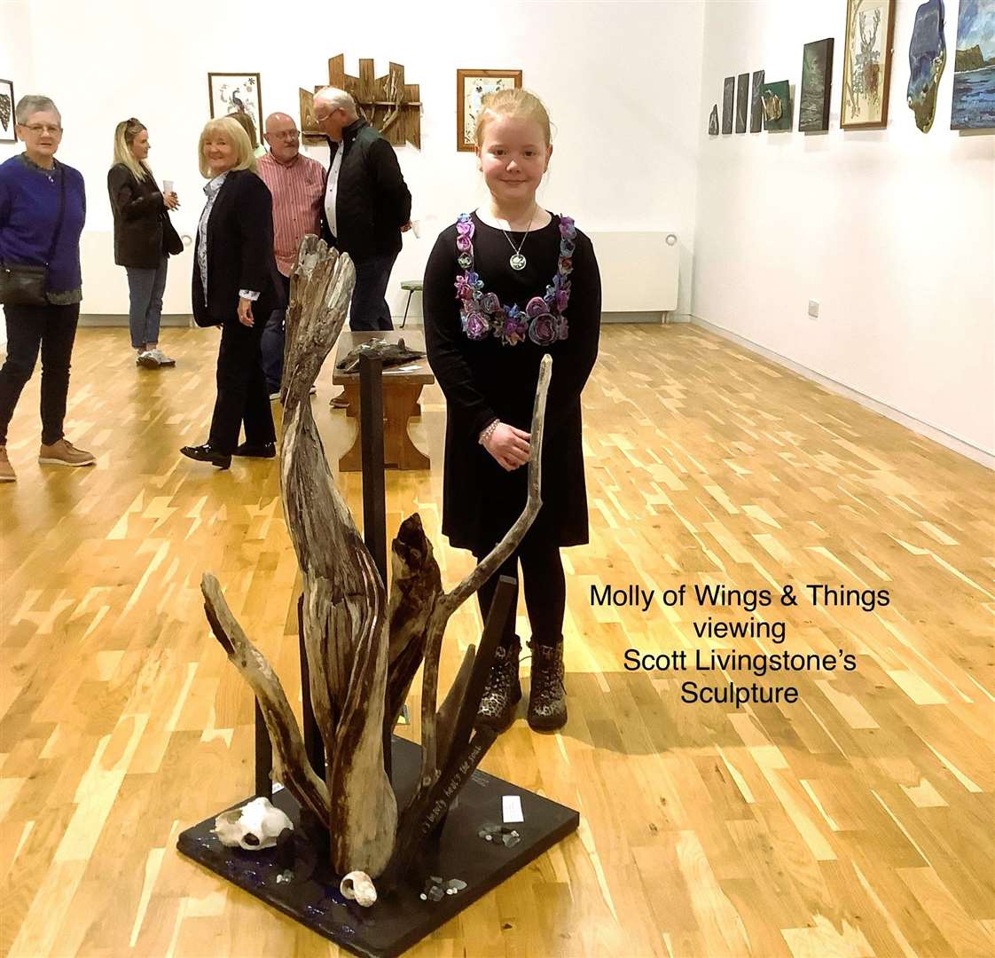 Young artist and crafter Molly from Wings and Things beside Scott Livingstone's sculpture.