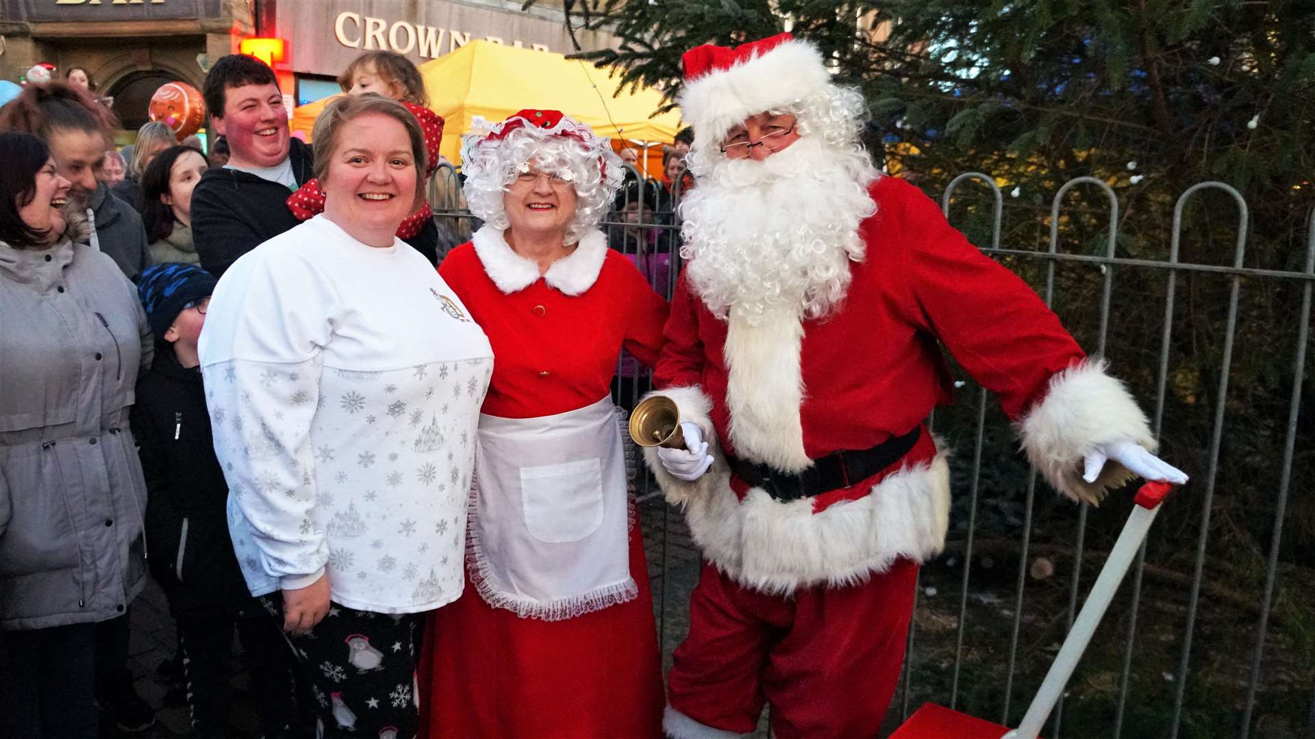 Claire Mackenzie of the Wick Christmas Lights Committee, left, with Santa and Mrs Claus just before the lights were officially switched on in Wick's town square. Picture: DGS
