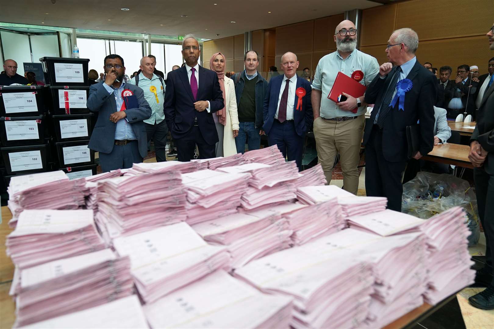 Lutfur Rahman (second left) and John Biggs (third right) waiting for the results (Aaron Chown/PA)