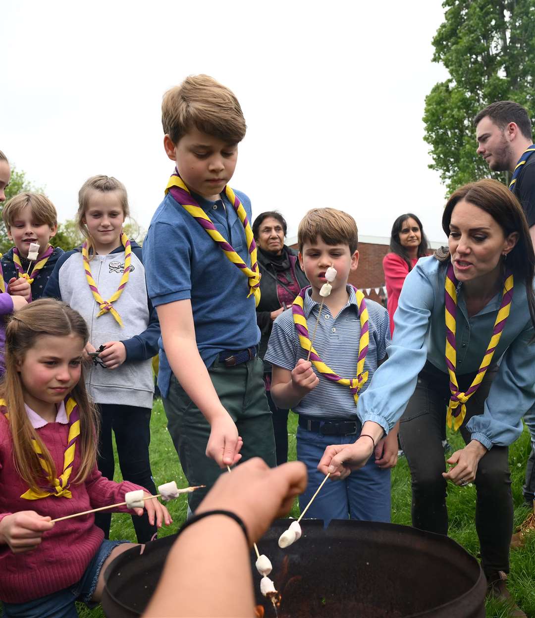 Princess Charlotte, Prince George, Prince Louis and the Princess of Wales toast marshmallows as they join volunteers to help renovate and improve the 3rd Upton Scouts Hut in Slough, as part of the Big Help Out, to mark the coronation in May (Daniel Leal/PA)