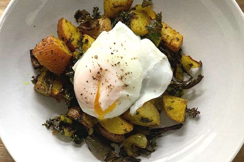 Curried potato, kale and onion hash with poached eggs.