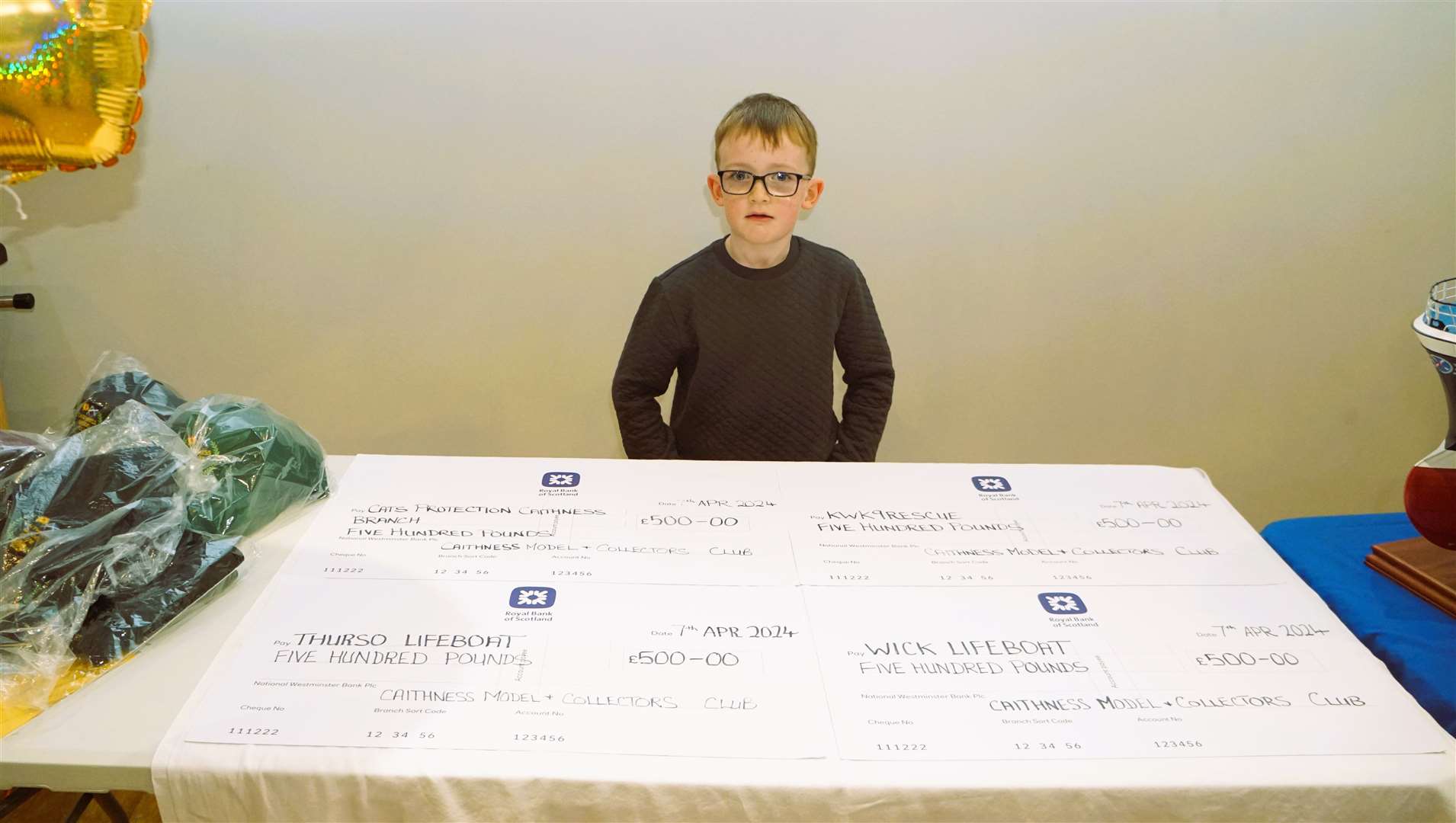Young Oscar Tait from Murkle looks after the charity cheques. Picture: DGS