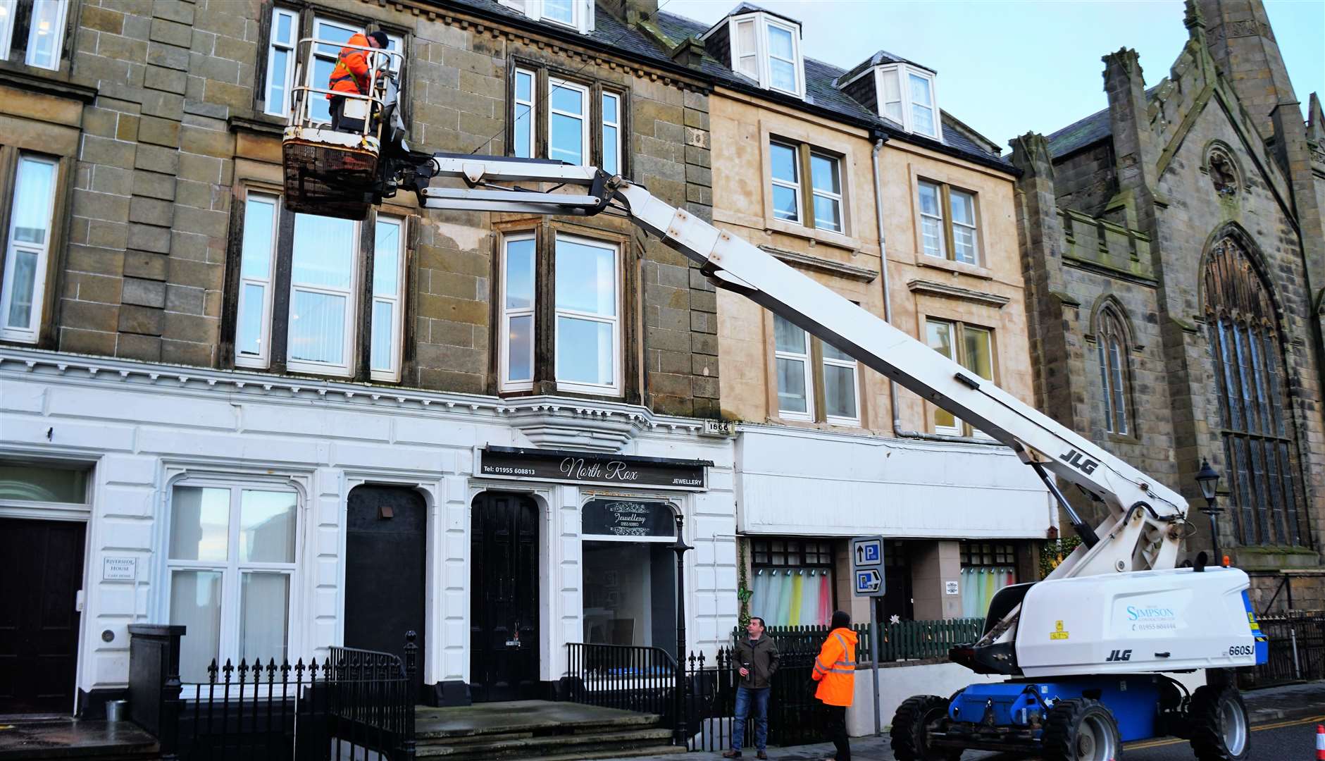 Volunteer Steven Sinclair goes up to clean guttering at the Riverside Nursing Home on Wick's Bridge Street. Picture: DGS