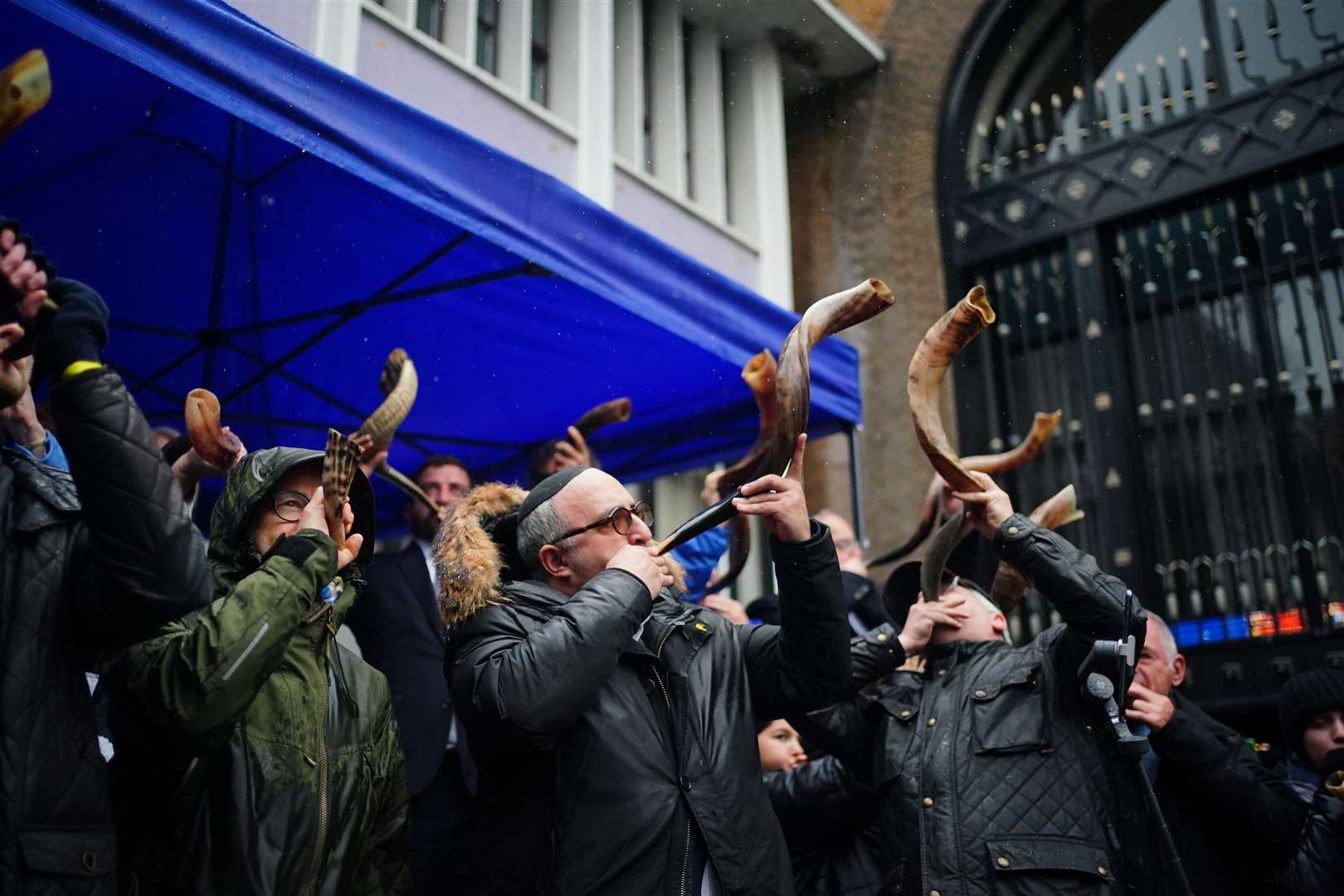 People blowing shofars and whistles in Abbey Road (Victoria Jones/PA)