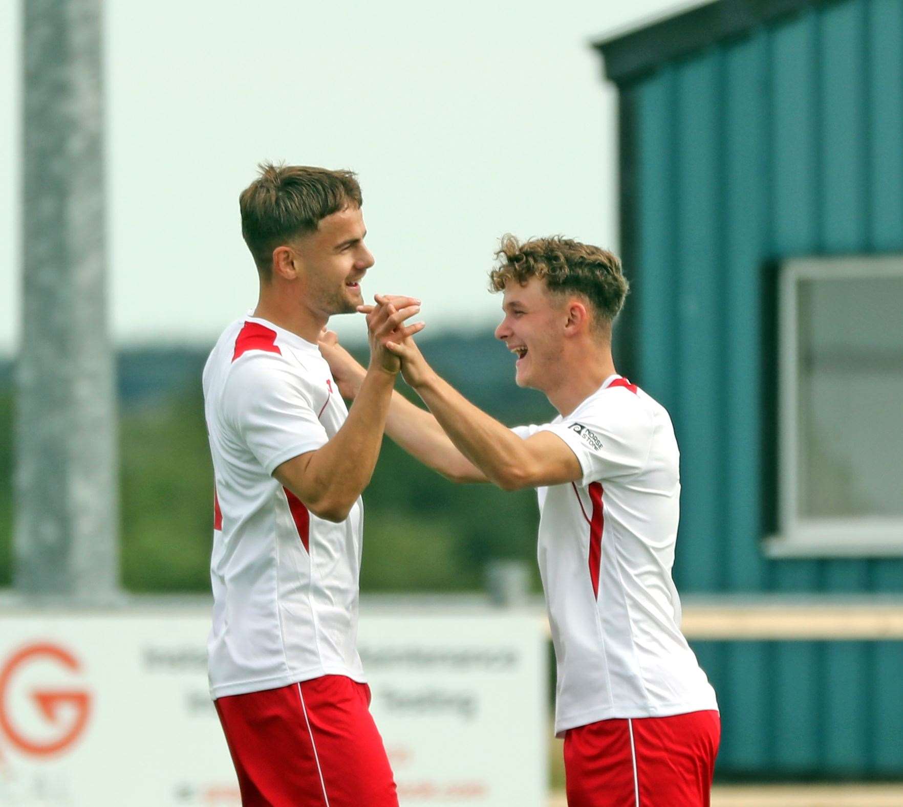 Mark Munro (right) congratulates Jonah Martens on scoring his second