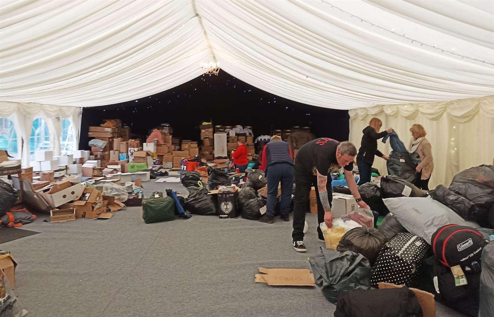 Some of the volunteers getting on with the task of sorting donations in the Stemster House marquee.