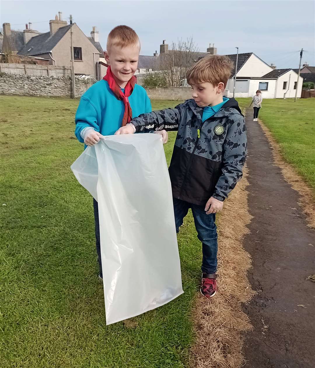 Two of the Beavers from 1st Wick Scout Group preparing to pick up litter in the Green Road play park.