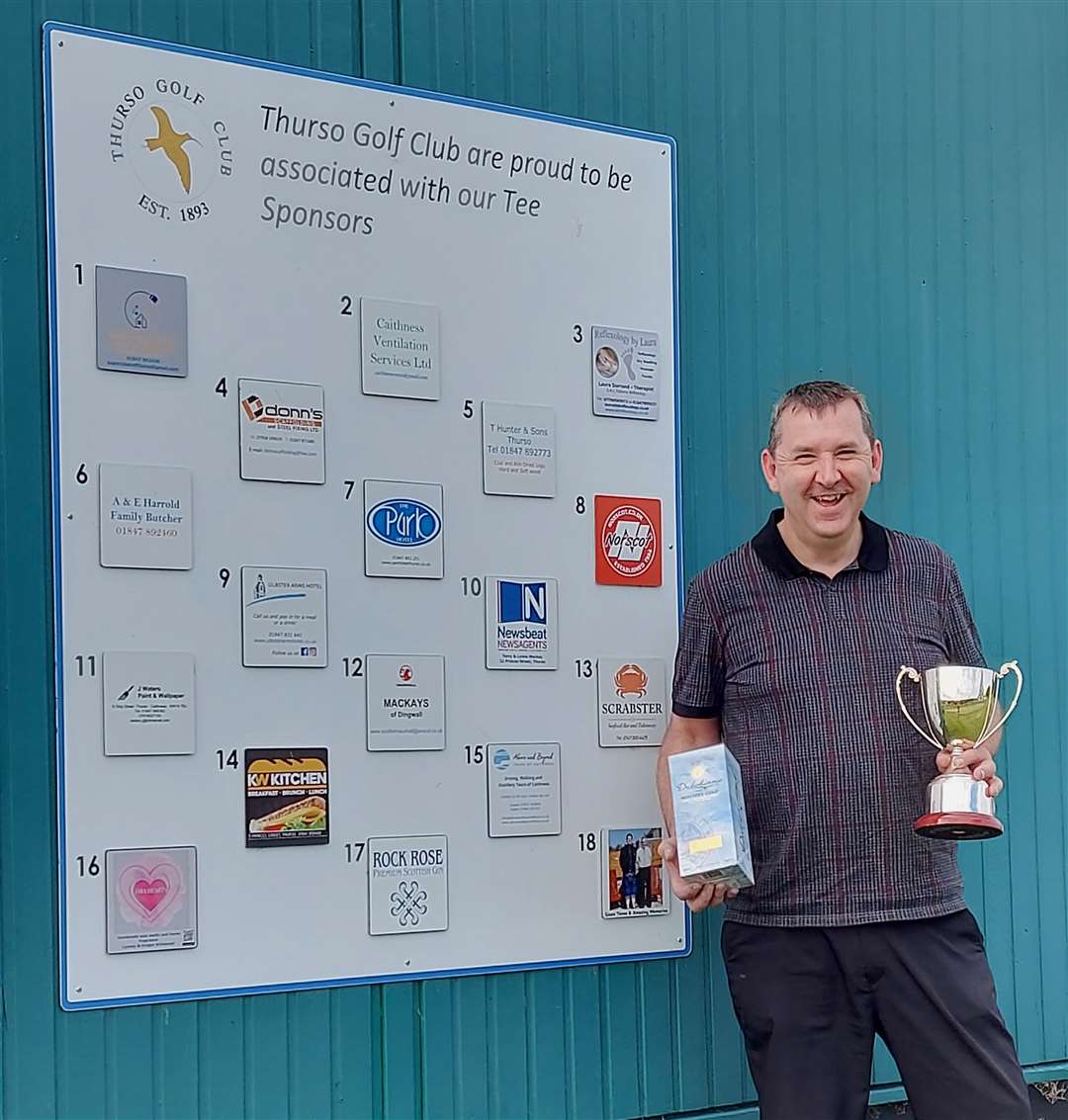 David Lyall Memorial Trophy winner Gary Leonard with the trophy and a bottle of malt whisky donated by Mary Lyall.