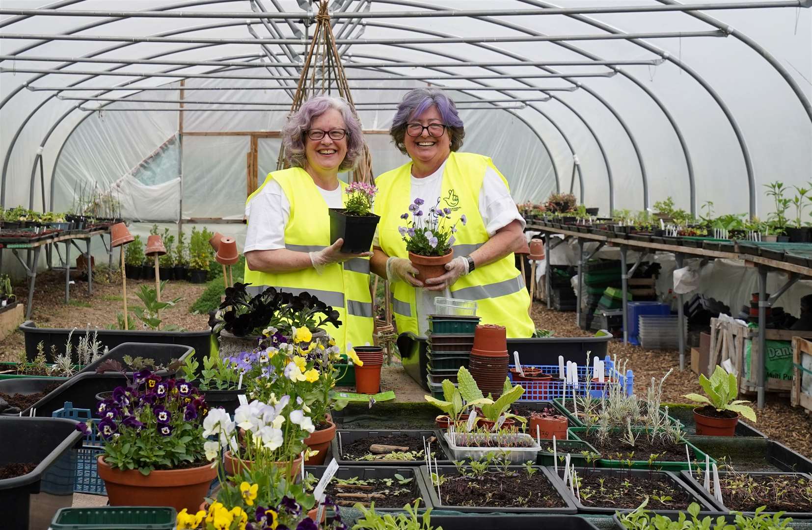 Beverly Cox (left) and Desiree Home of the Winners Workforce plant seeds after volunteering to help the Veterans’ Growth charity(Gareth Fuller/PA Wire)