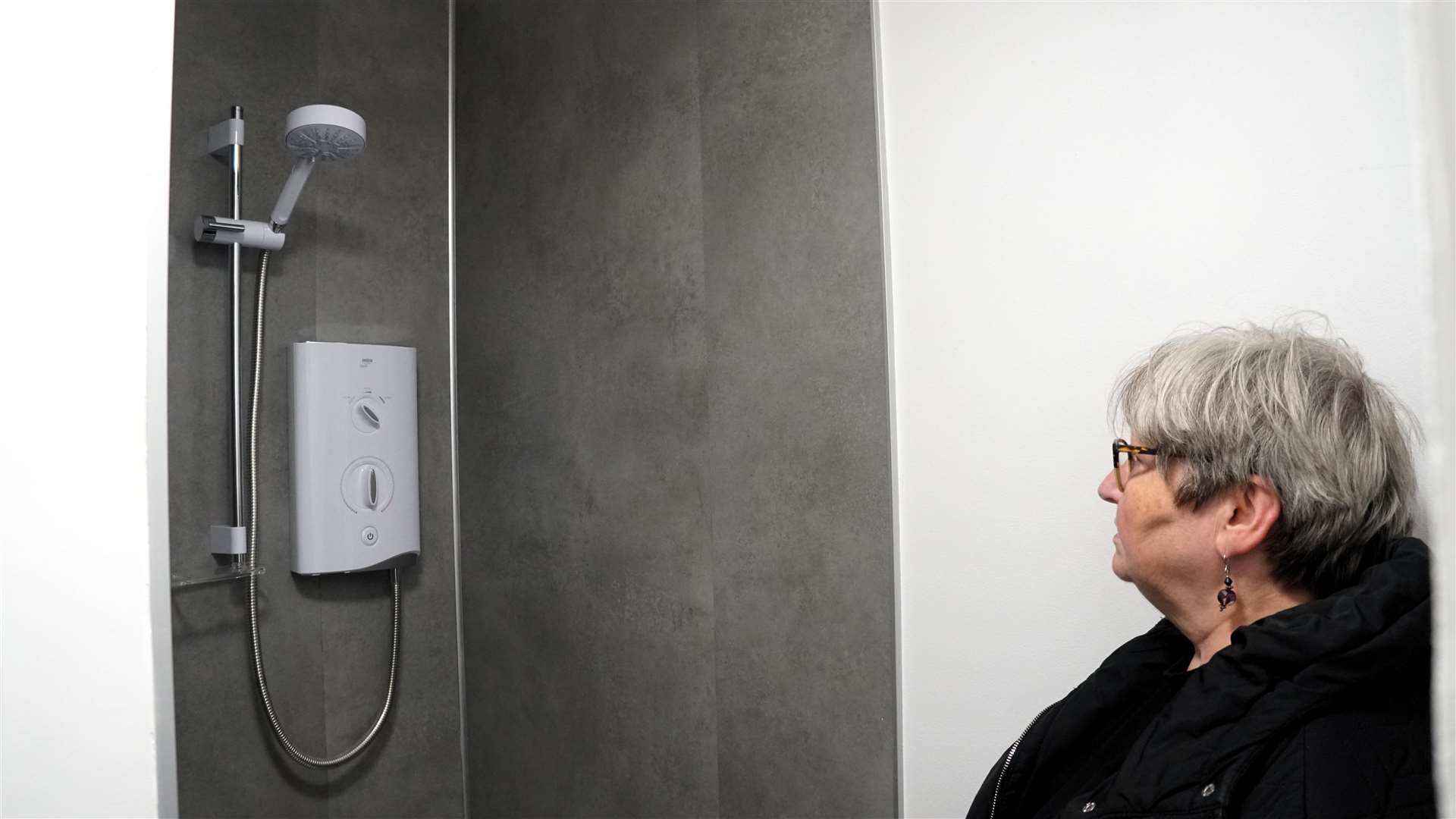 Wick provost Jan McEwan looks inside a shower cubicle. Picture: DGS