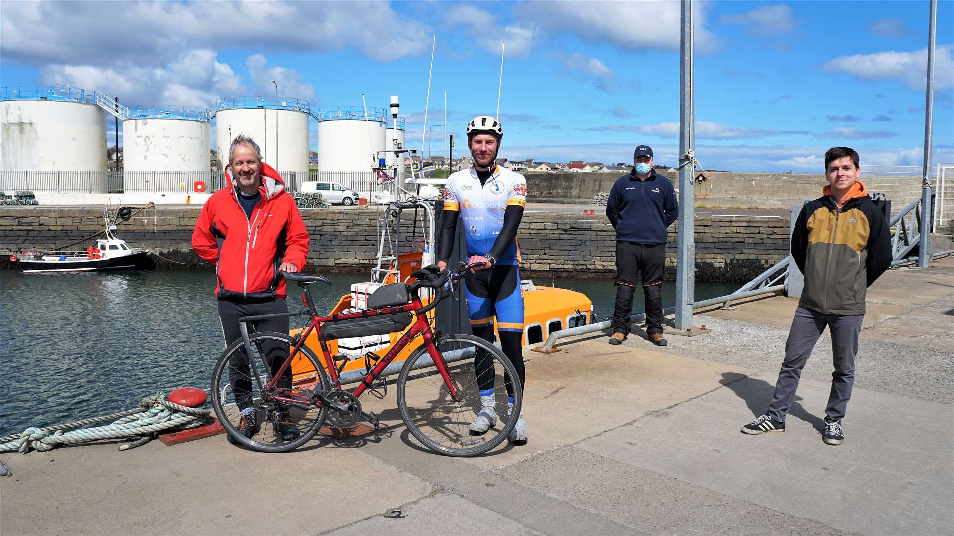 From left, trip sponsor Professor Iain Baikie, cyclist Harry Lidgley, Wick lifeboat mechanic Johnny Grant representing the rest of the crew and Professor Baikie's son Joni who knew Harry from Cambridge University. Picture: DGS
