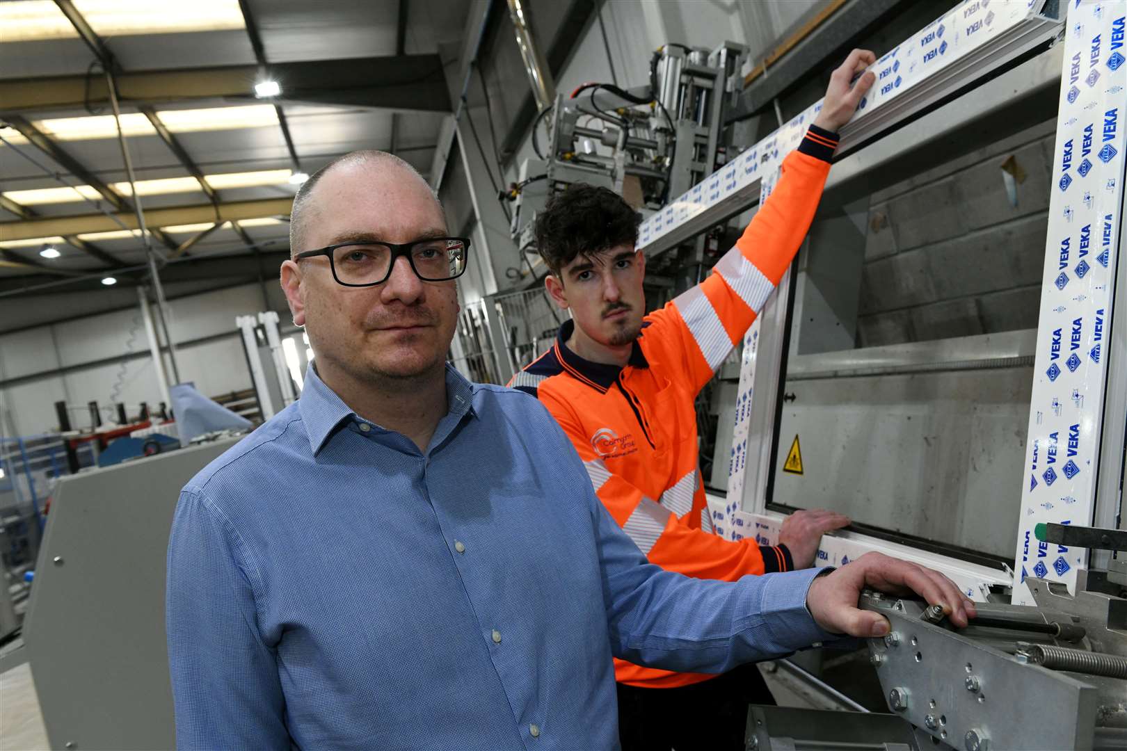 Chris Dowling (left), who is also joint managing director of the Cairngorm Group, is pictured with Mike Jasz, a trainee window fabricator, Picture: Callum Mackay.