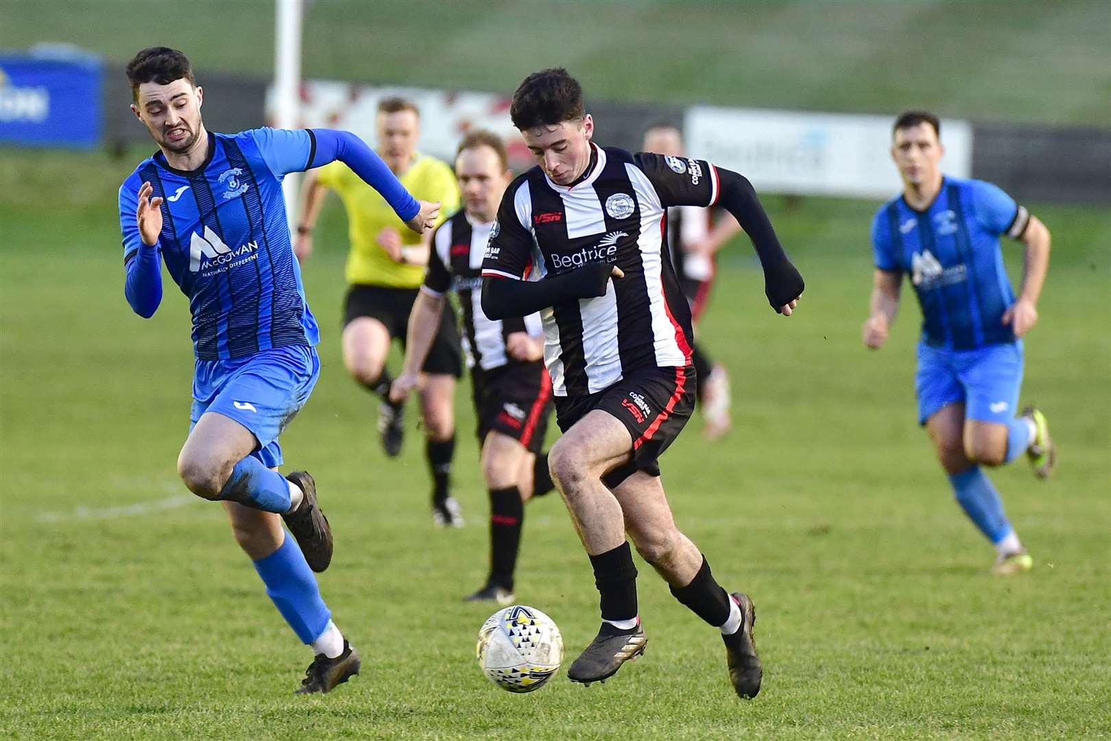 Wick Academy's Kyle Henderson pushes forward, chased by Strathspey Thistle's Ewan Neil. Picture: Mel Roger