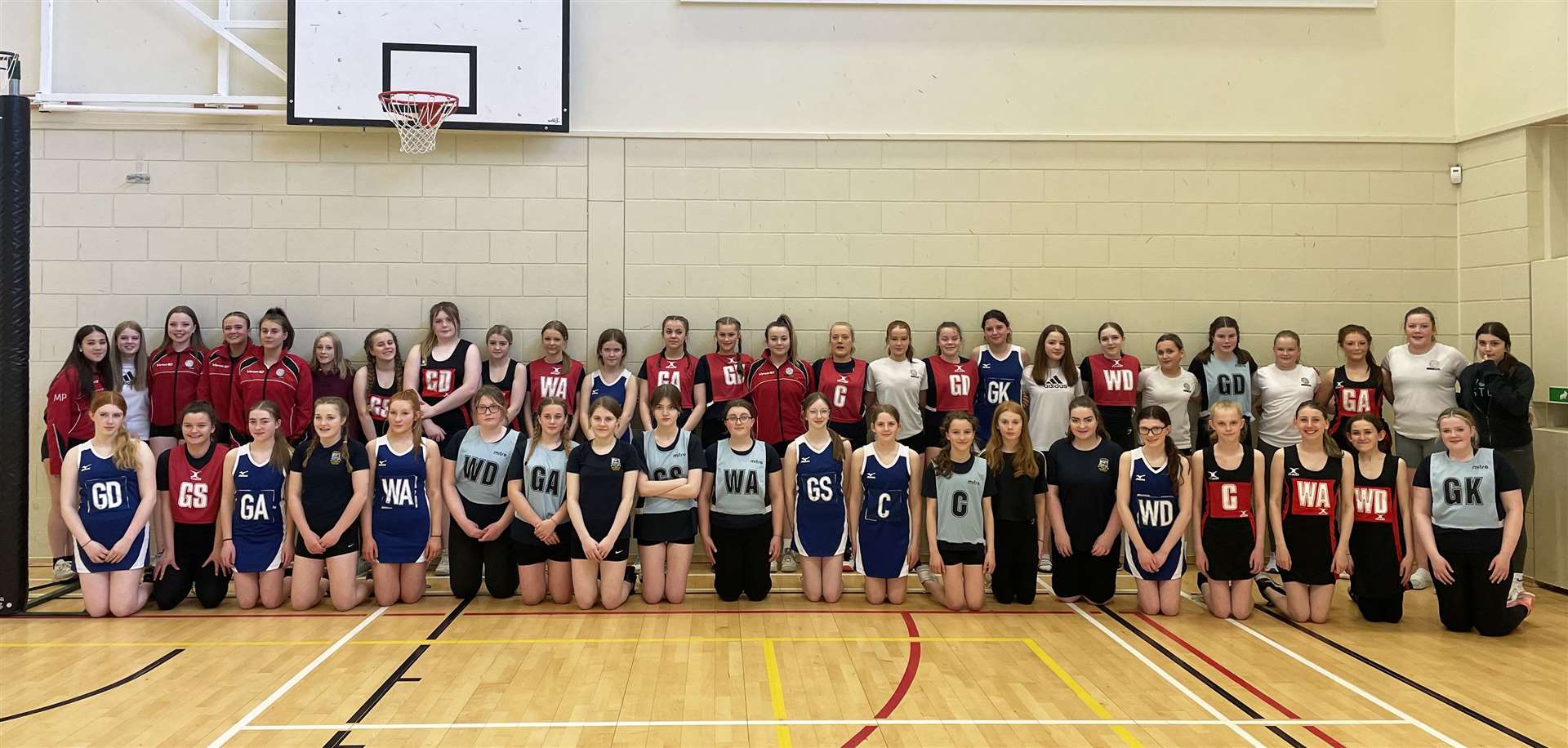 All six teams from the four schools at the netball festival in Kirkwall Grammar School, with Thurso in black and red and Wick in blue.