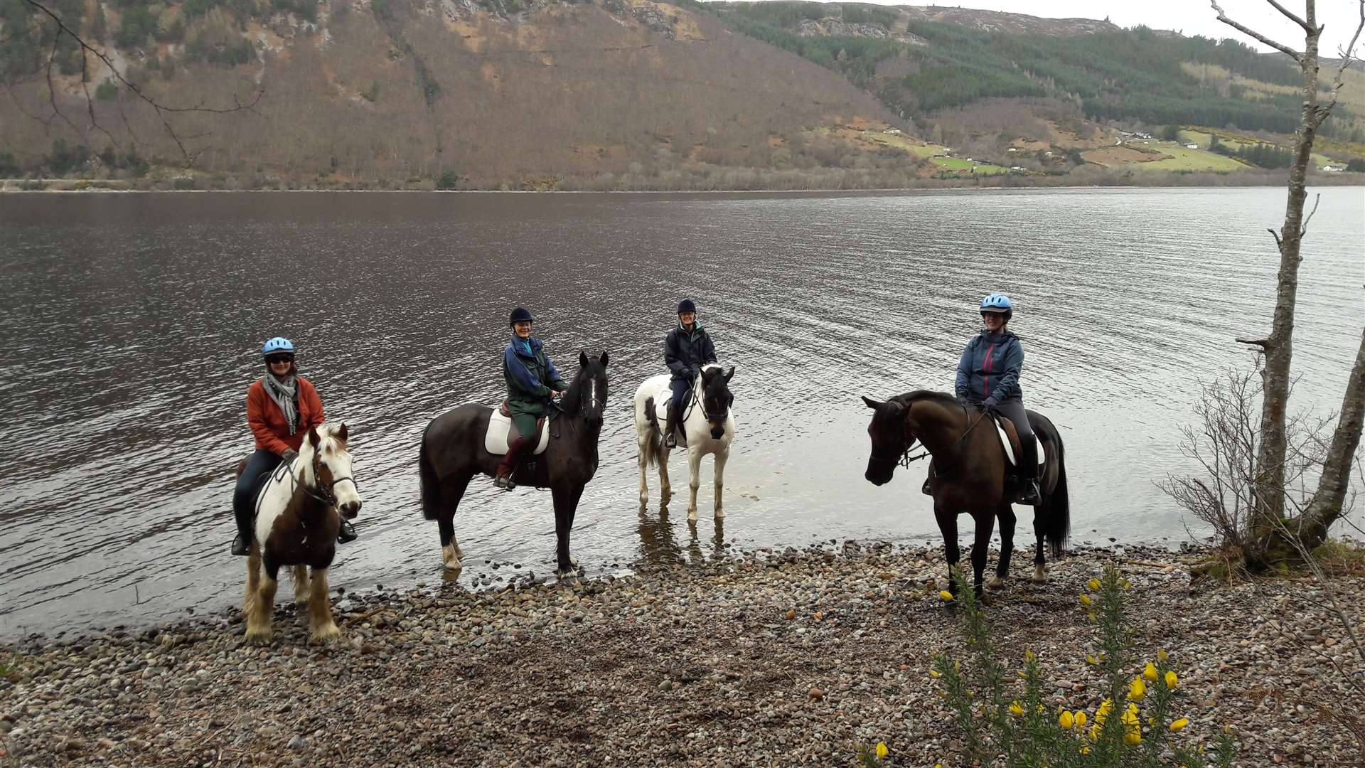 Horse riders on an excursion with Loch Ness Riding.