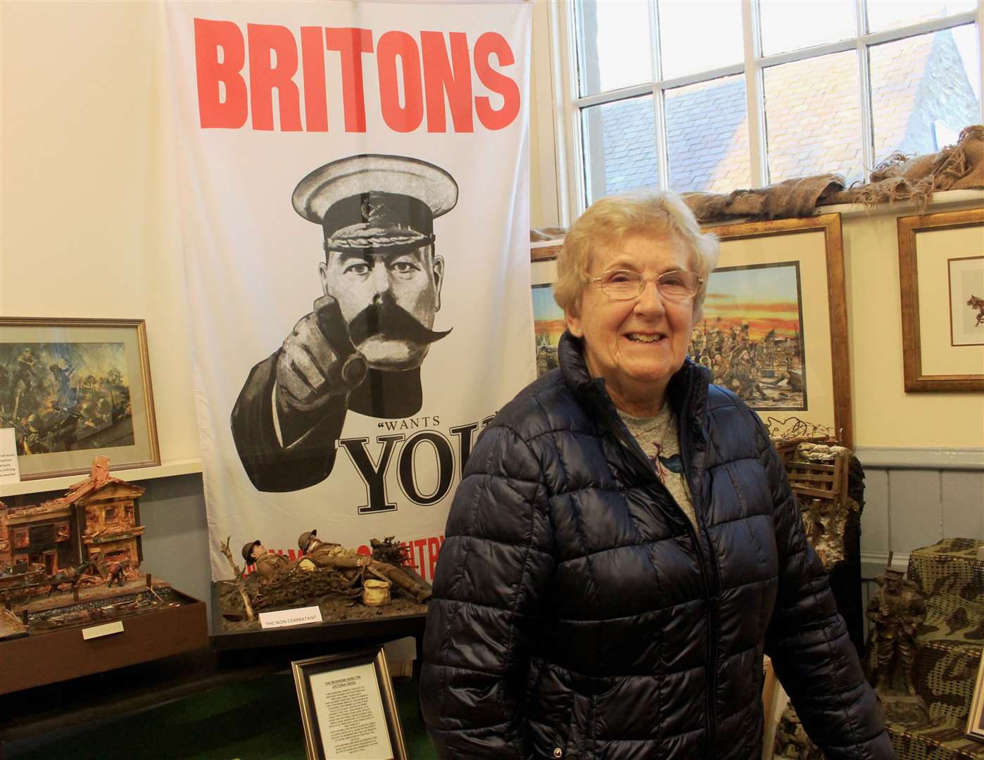 Committee member Linda Munro alongside some of the war exhibits.