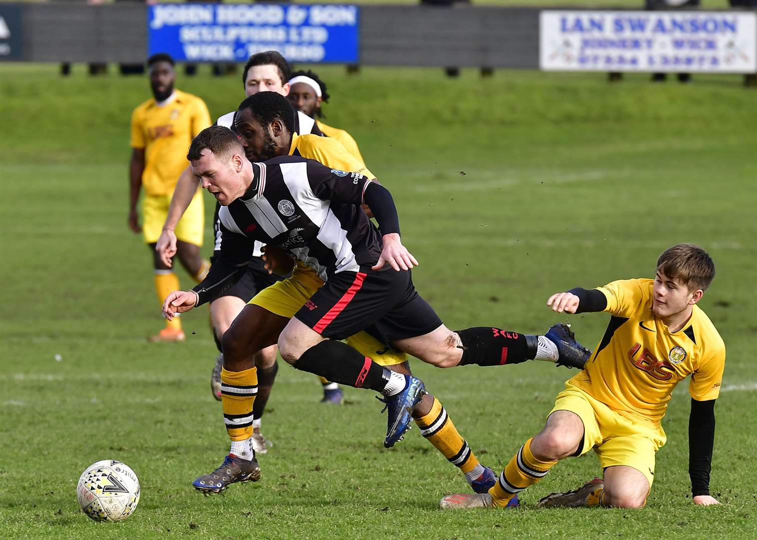 Wick Academy's Gordon MacNab is brought down by Fort William's Joshua Niblock. Picture: Mel Roger