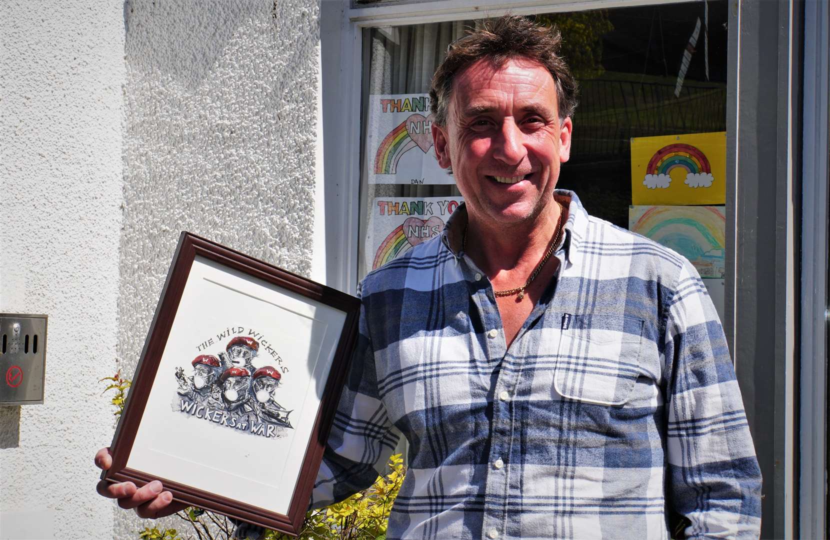 Scott Youngson walked 23 miles to pick up the artwork which he is now donating to Caithness General Hospital along with a cheque for £700. Picture: DGS