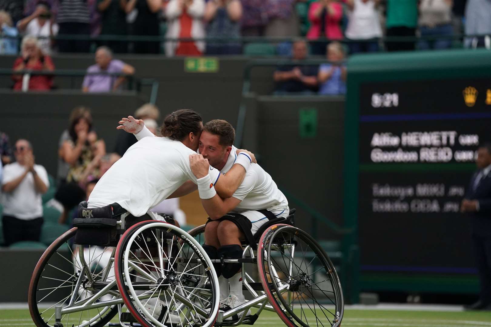 Alfie Hewett and Gordon Reid celebrate victory in the wheelchair doubles final (PA)