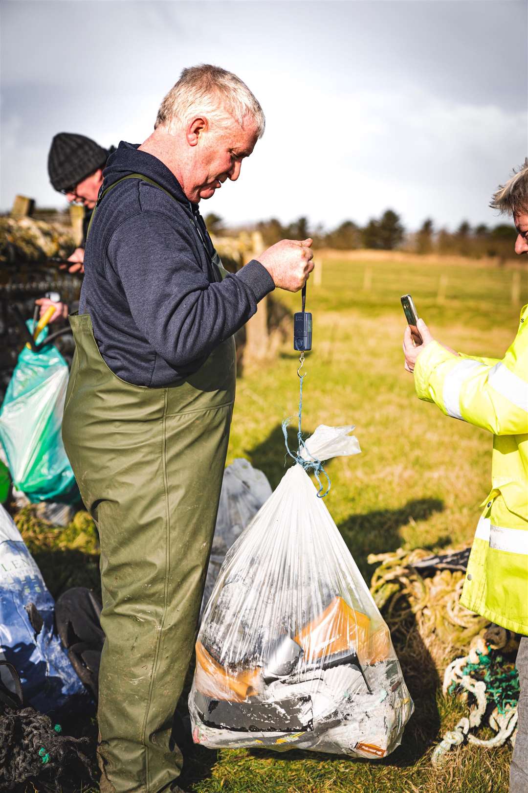 David Thompson holding up a bag to be weighed for the Caithness Beach Cleans group. Picture: Stevie Bruce