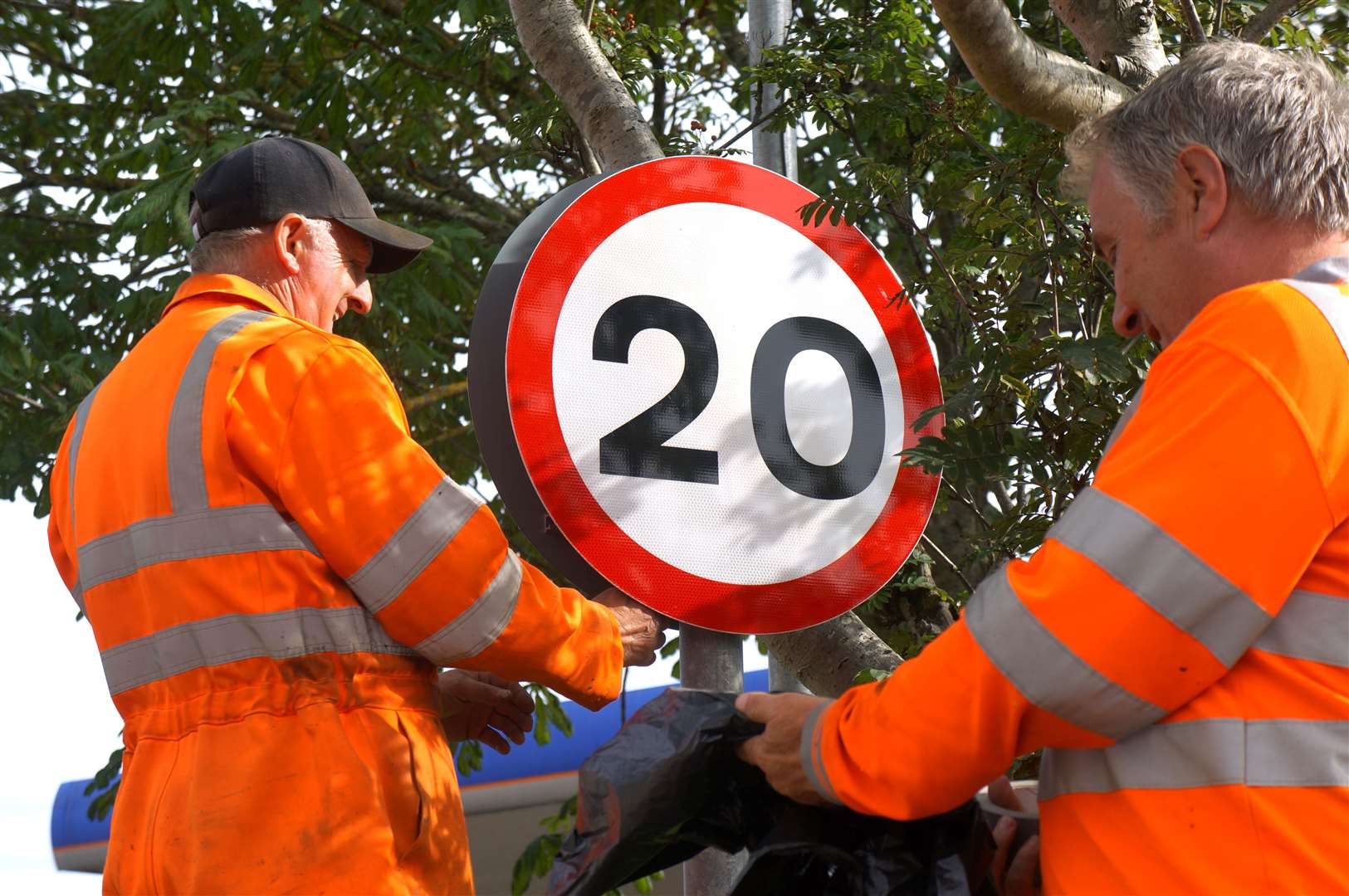Workmen installing a new 20 mph sign in Wick's Dempster Street. Picture: DGS