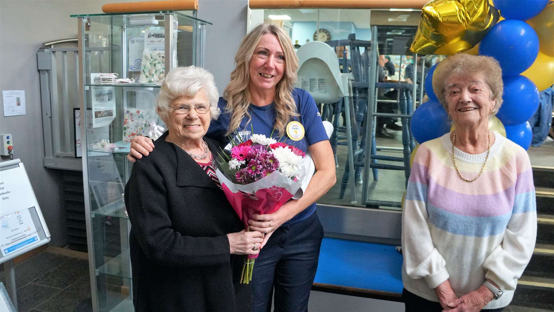 Doreen Bannerman, left, gave flowers to Karen Center on behalf of the lunch club. On the right is Kathleen Sinclair, one of the club's oldest member at age 91. Picture: DGS