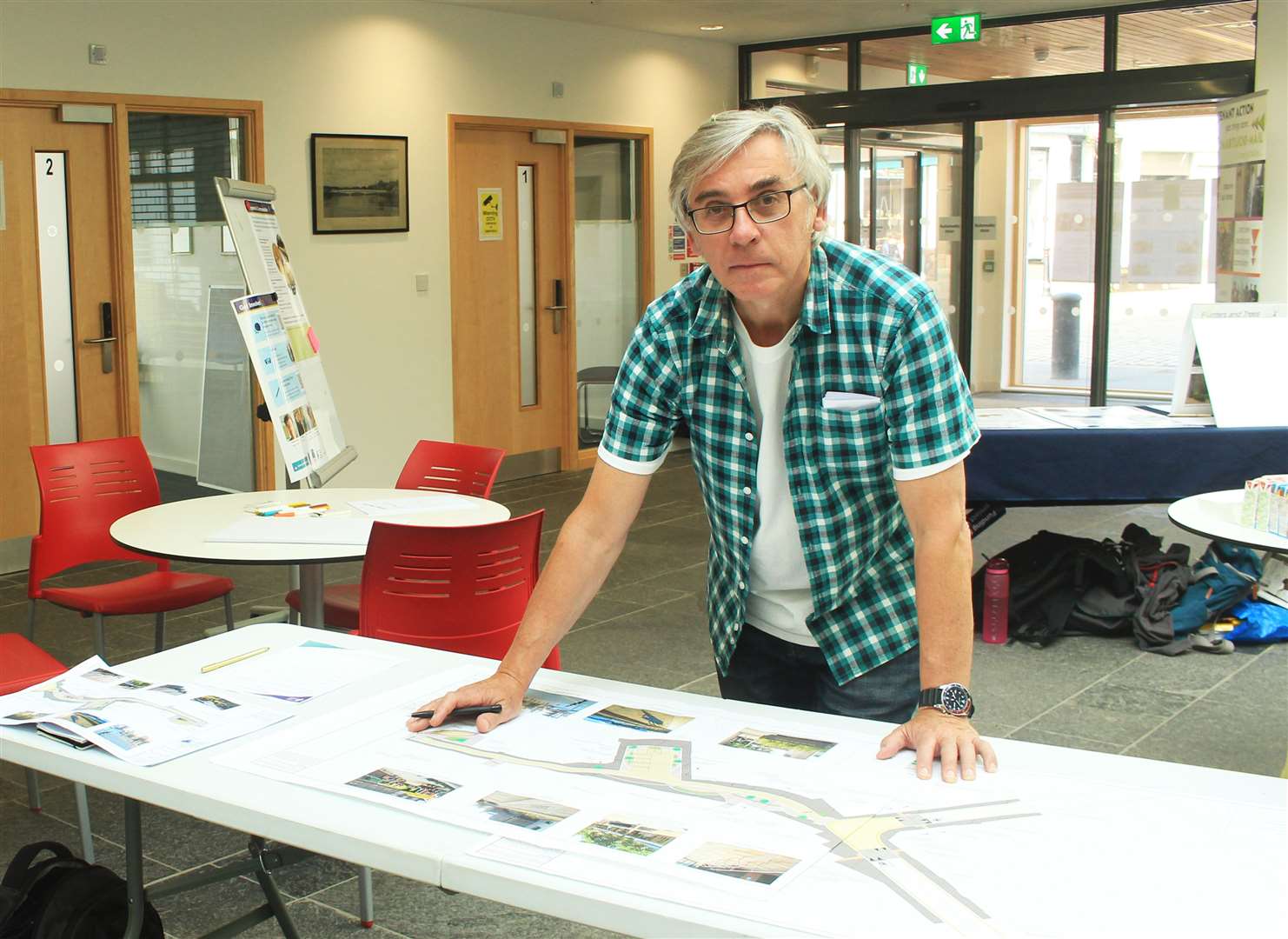 Allan Farquhar, chairman of the Royal Burgh of Wick Community Council, looking over some of the design ideas during the Wick Lanes Pocket Places drop-in event this week. Picture: Alan Hendry