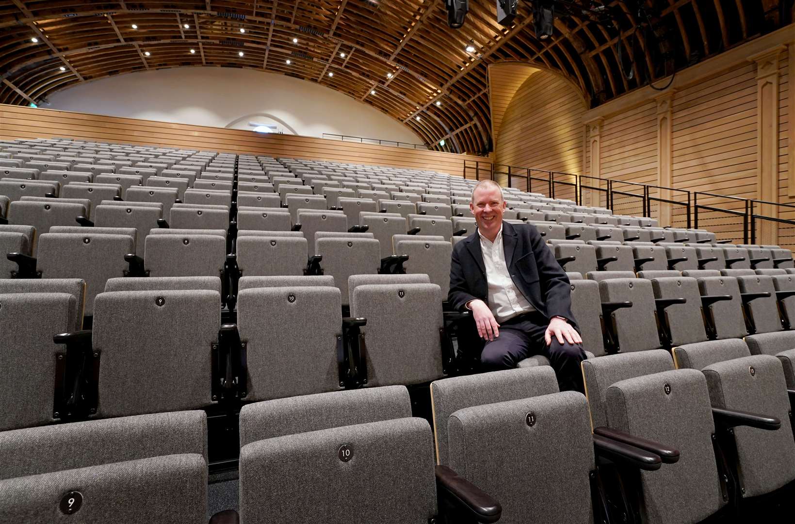 Andrew Comben, chief executive of Brighton Dome and Brighton Festival sits in the newly refurbished Corn Exchange and Studio Theatre buildings (PA)