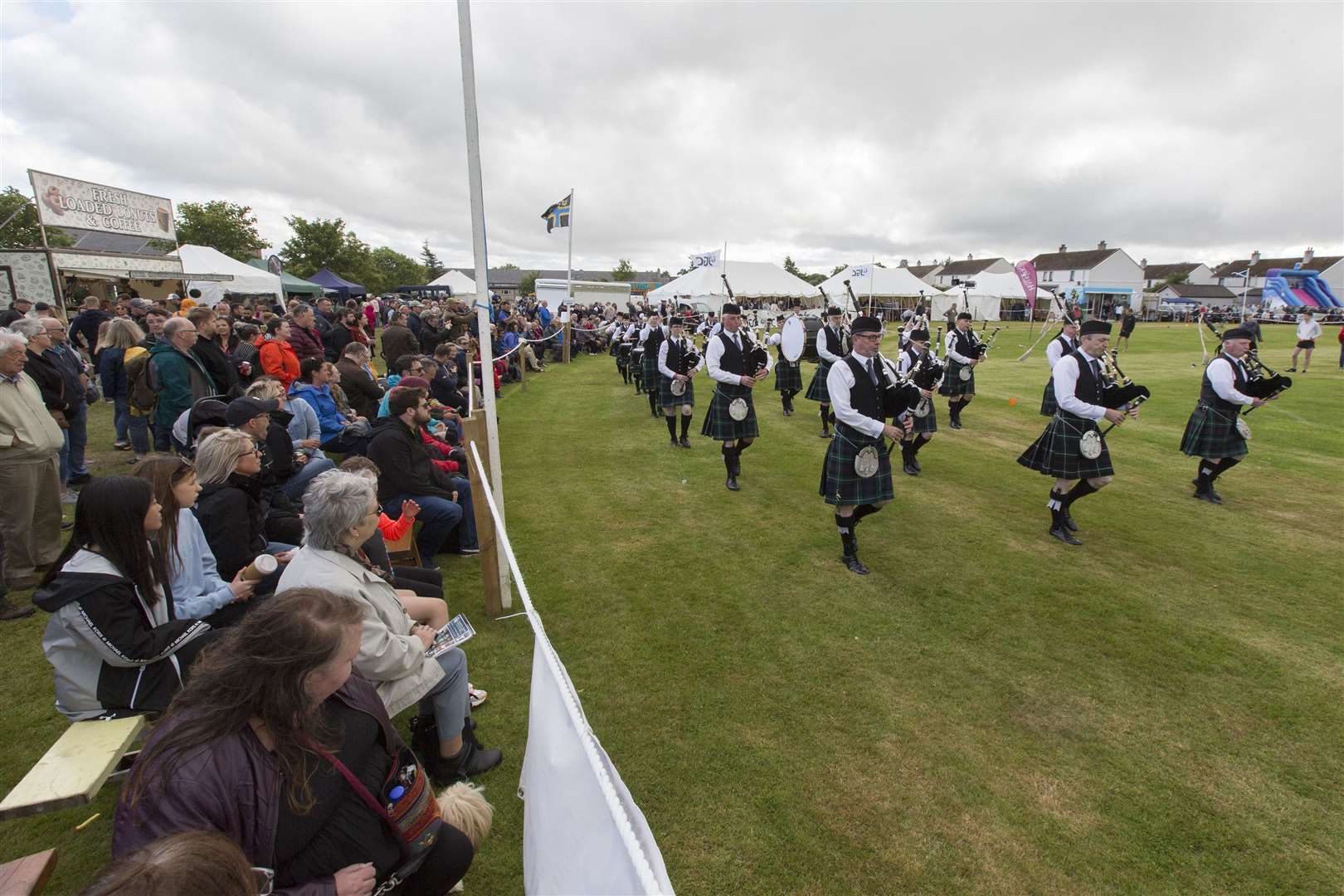 A packed ringside watches the parade by Wick Royal British Legion Pipe Band. Picture: Robert MacDonald/Northern Studios