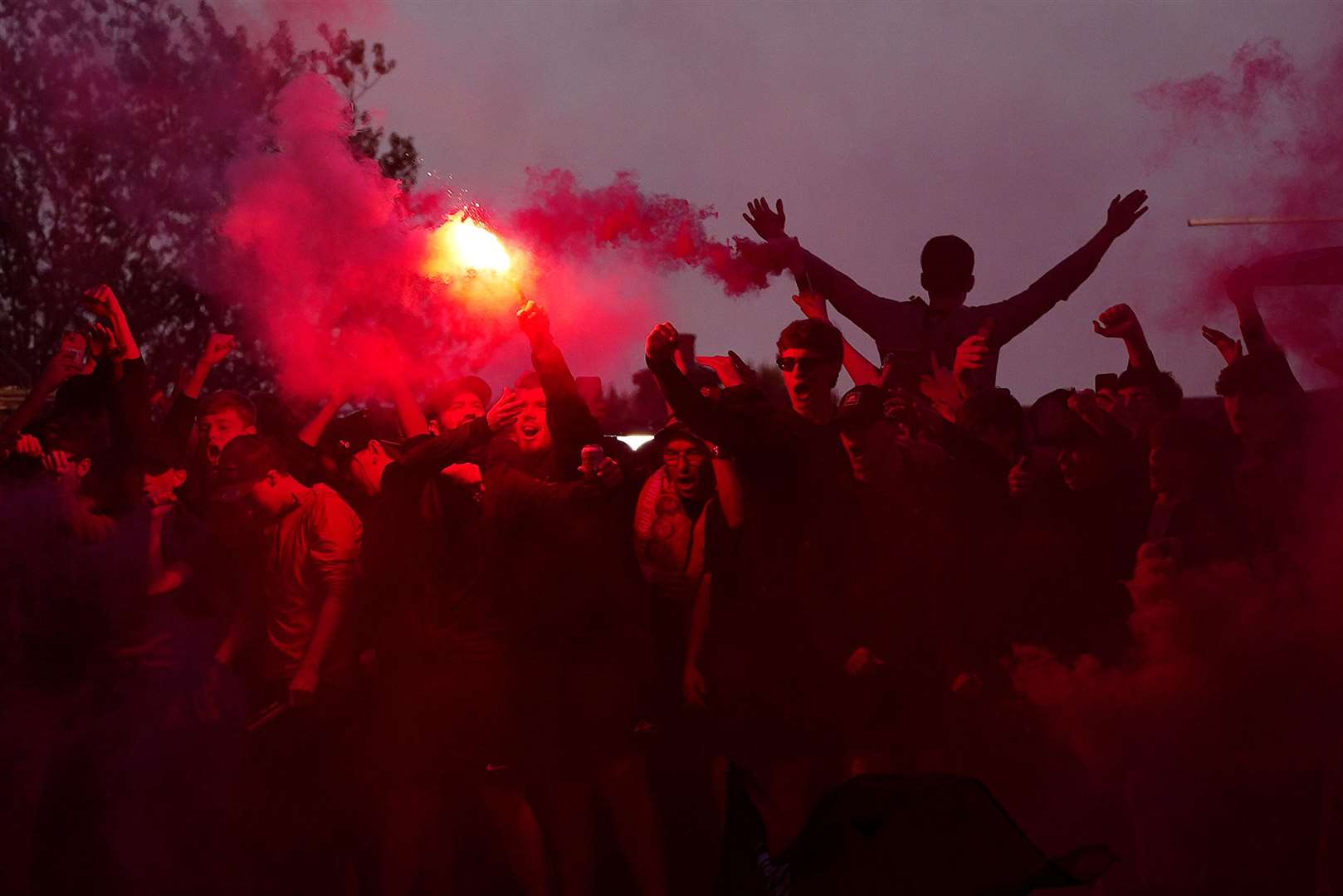 Liverpool fans celebrate victory in the Premier League outside Anfield (Peter Byrne/PA)