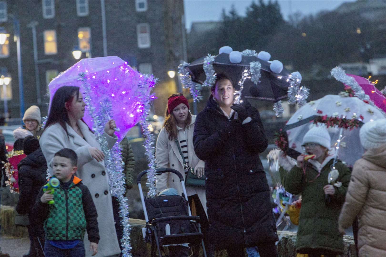 Umbrellas light up the Wick riverside as they wait for the parade to start. Picture: Robert MacDonald / Northern Studios