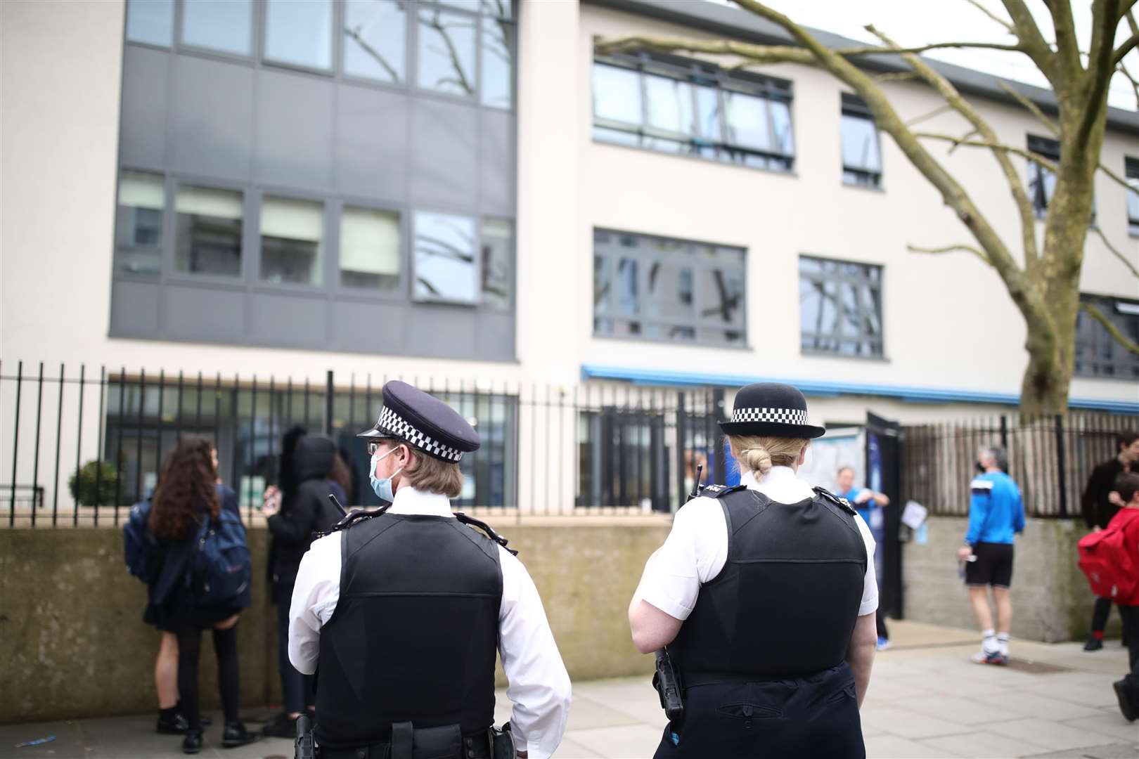 Police officers outside Pimlico Academy after pupils walked out early (Aaron Chown/PA)