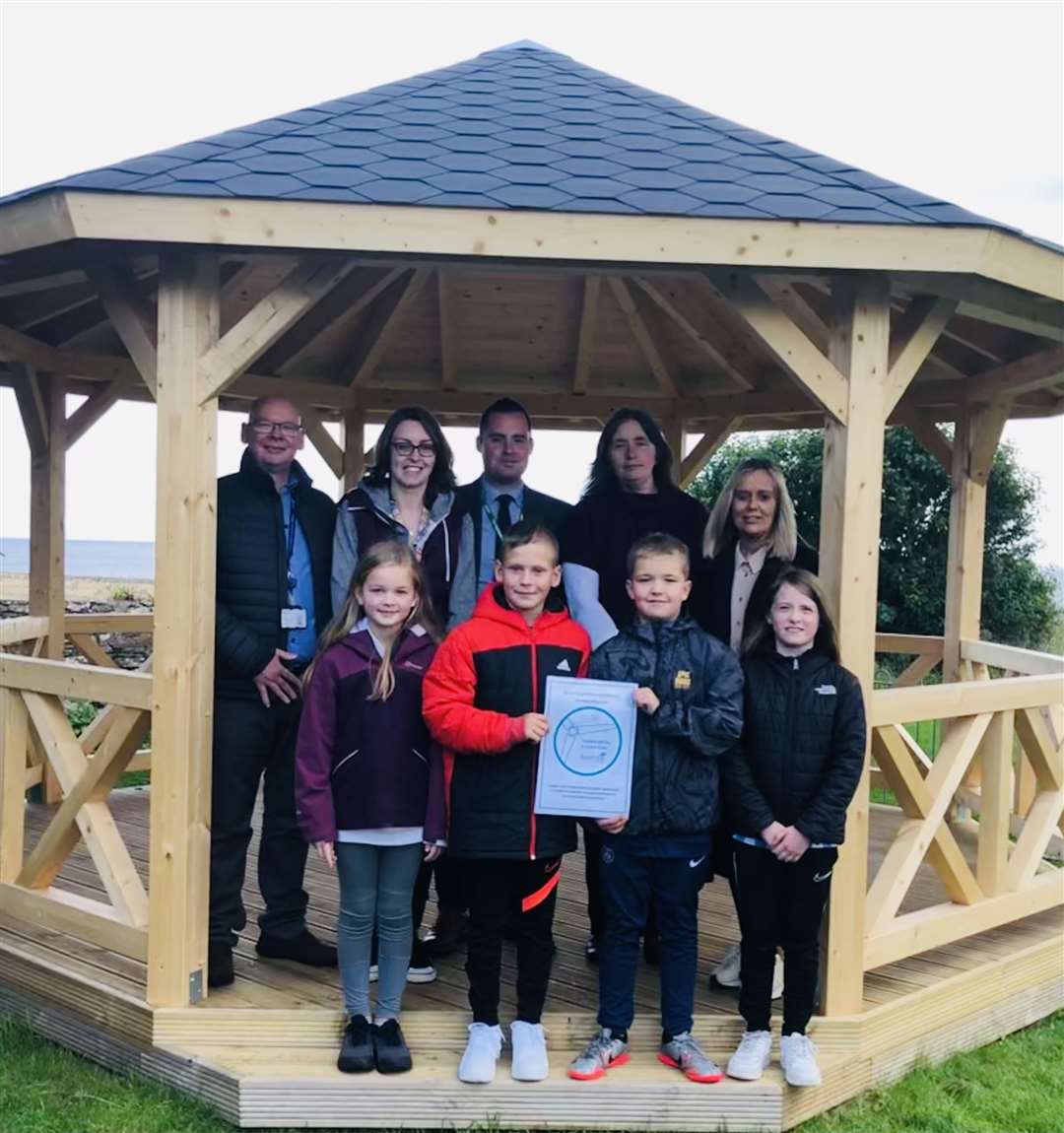 Left to right: David Shearer of SSE Renewables, class teacher Olivia Bremner, Fraser Thomson, head teacher, Treasa Hamilton, secretary, of the parent council, and class teacher Gillian Munro with house captains Paige Ronaldson, Charlie Breeze, Rory Green and Ella Mackenzie.