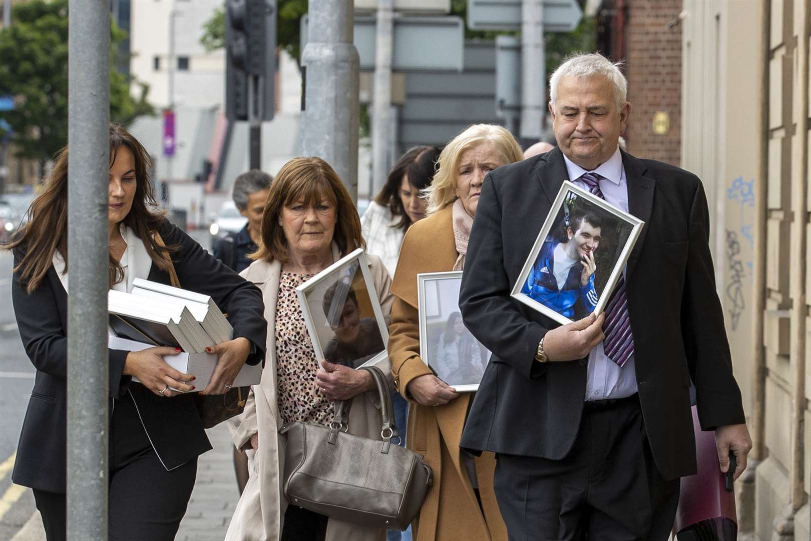 Family and supporters of patients of Muckamore Abbey Hospital outside the Corn Exchange, Cathedral Quarter in Belfast, as the first day of public hearings in the Muckamore Abbey Hospital Inquiry is under way (Liam McBurney/PA)