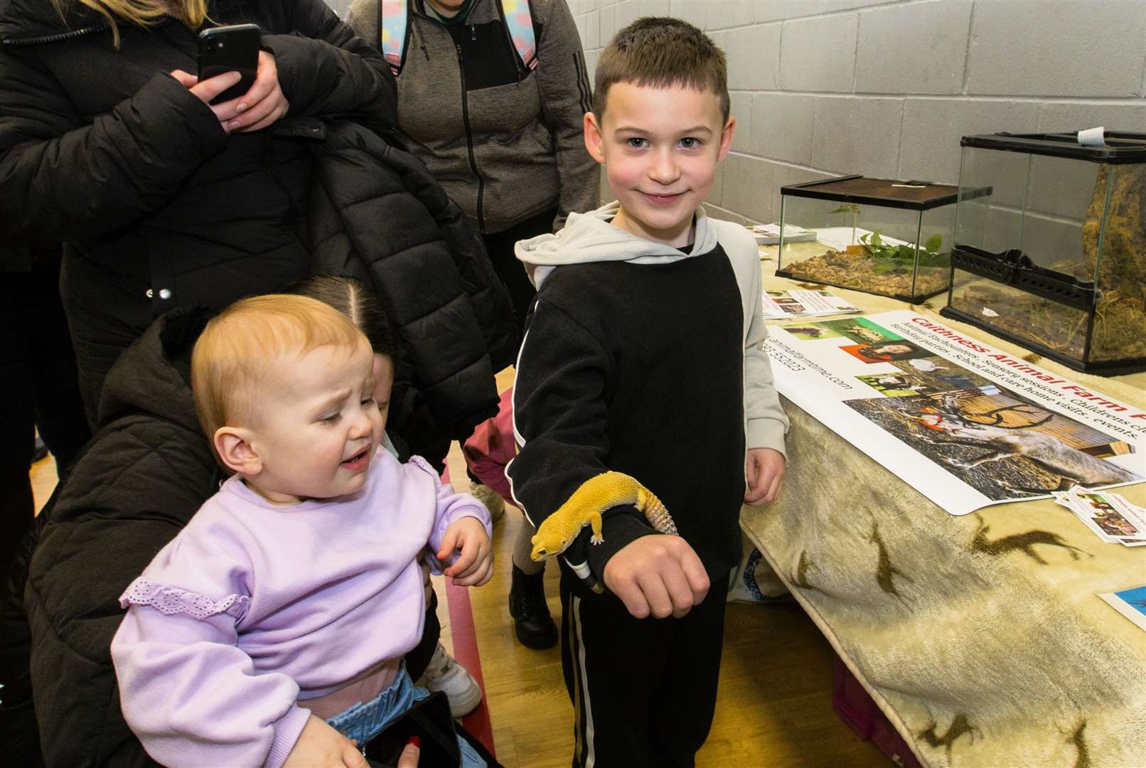 Leo the leopard gecko meets Lyle Logan (right) from Thurso and Keryis Edwards from Wick. Keryis doesn't look too happy! Photo: Robert MacDonald/Northern Studios