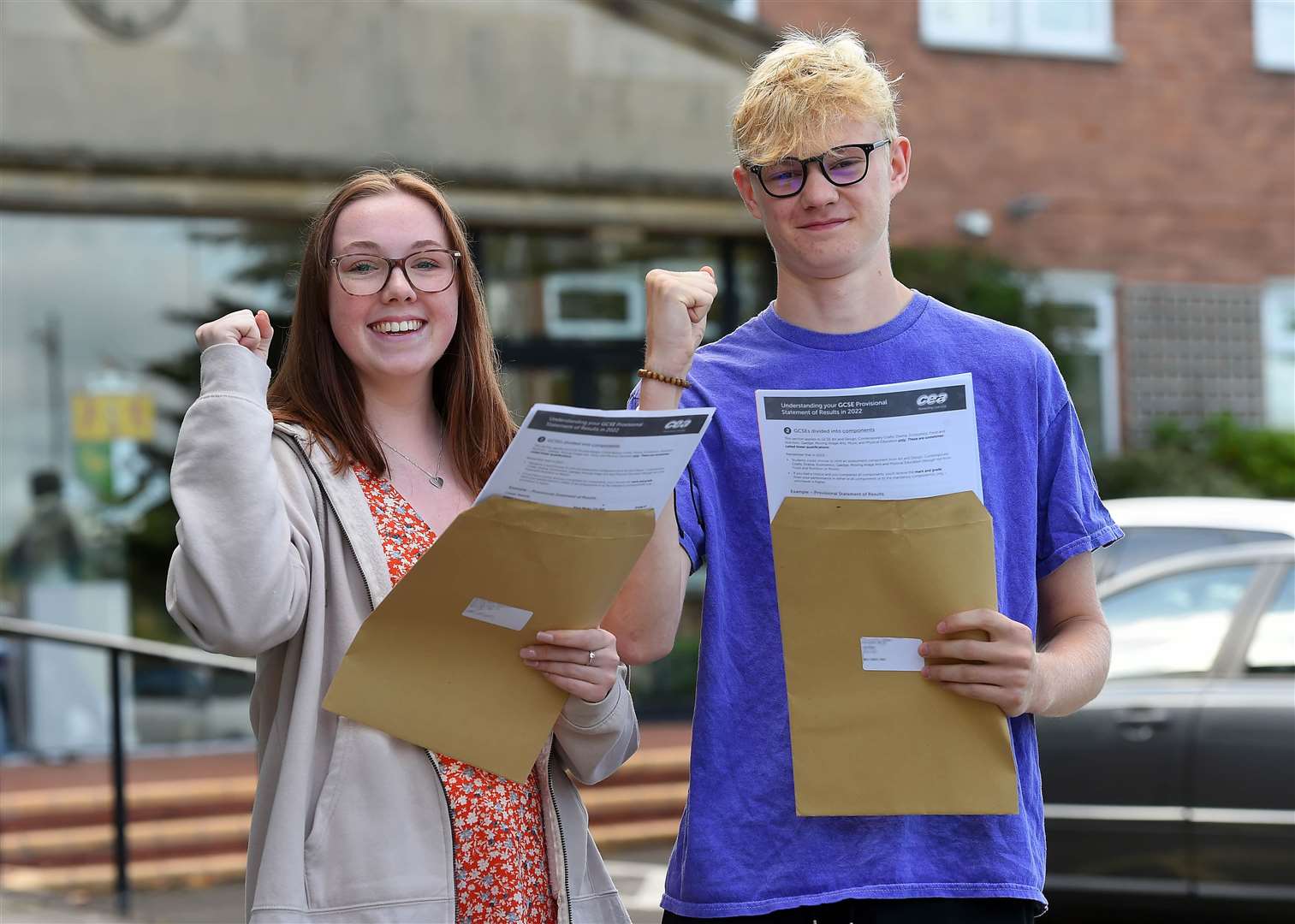 Abi Trainor and Ben Aiken, pupils at Sullivan Upper School in Holywood, Co Down, celebrate after receiving their GCSE results (Oliver McVeigh/PA)