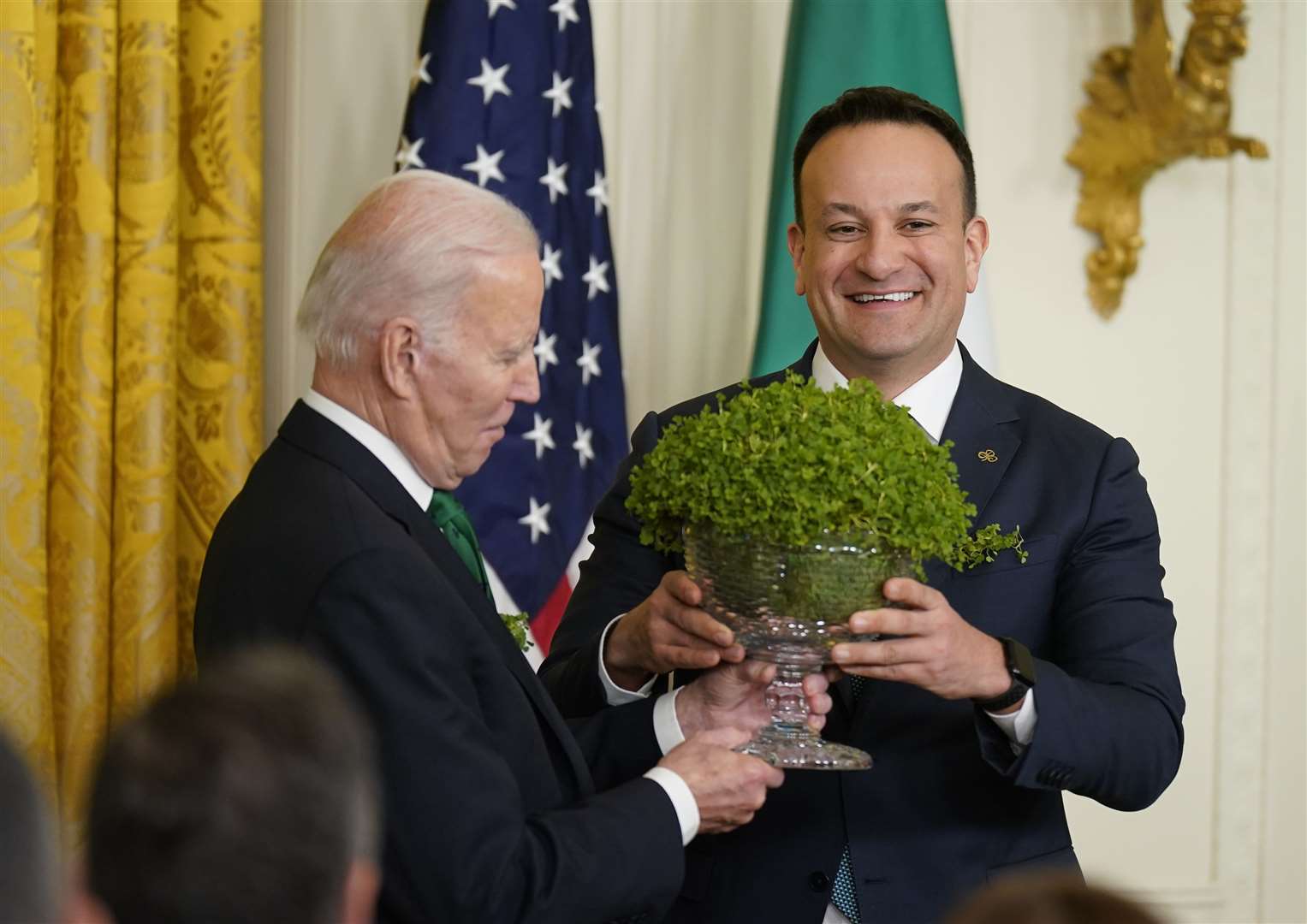Taoiseach Leo Varadkar presents Mr Biden with a bowl of shamrock during a St Patrick’s Day celebration at the White House in Washington (Niall Carson/PA)