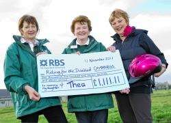 Caithness RDA members Maggie MacLean (left) and Agnes Innes along with Penelope Hamilton, who is holding Thea’s pink riding hat, and the £1111 cheque.