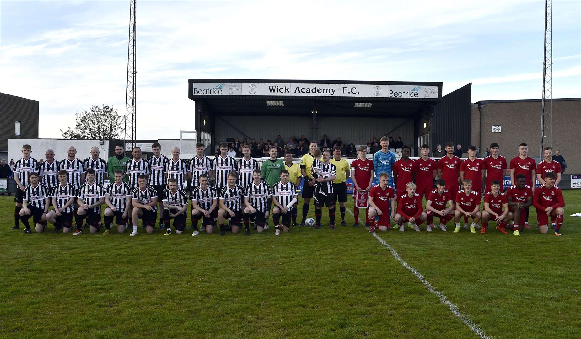 The Wick Academy and Aberdeen teams and match officials before the game, with Richard Macadie and son Oscar in the middle. Picture: Bob Roger