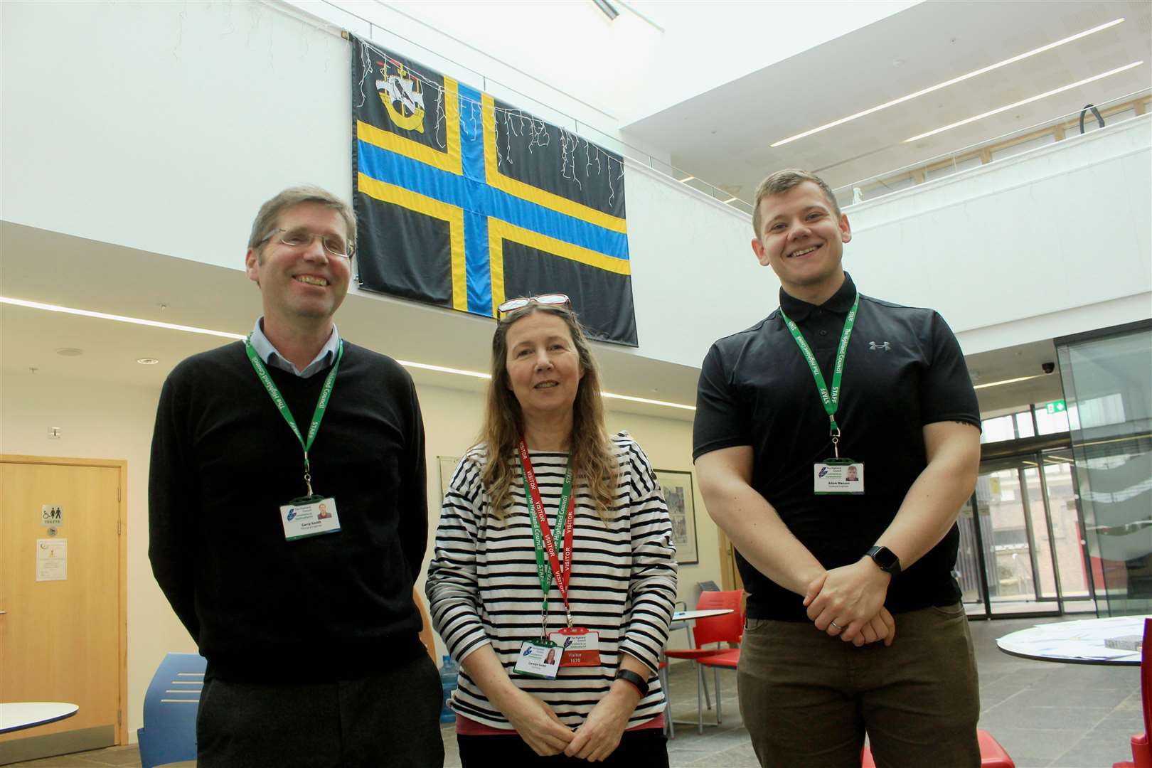 From left: Garry Smith, lead officer for infrastructure; Carolyn Smith, senior technician; and Adam Manson, graduate engineer, under the Caithness flag at the Wick town centre drop-in session on Friday.