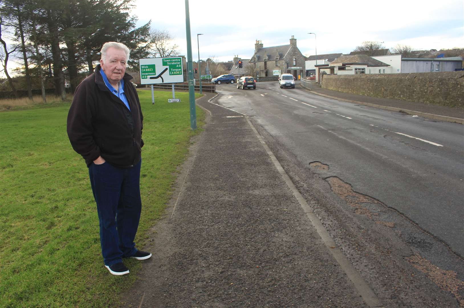John Sutherland on the section of pavement in Thurso where his wife had her fall. Picture: Alan Hendry