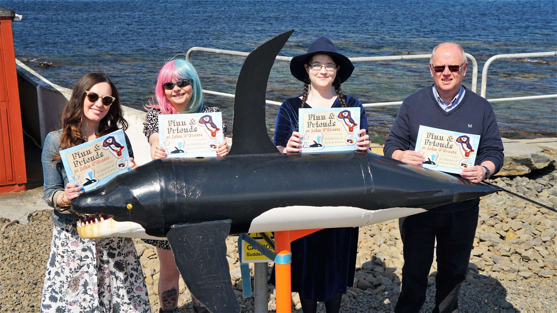The writers stand beside one of the book's characters, Finn the Orca. Picture: DGS