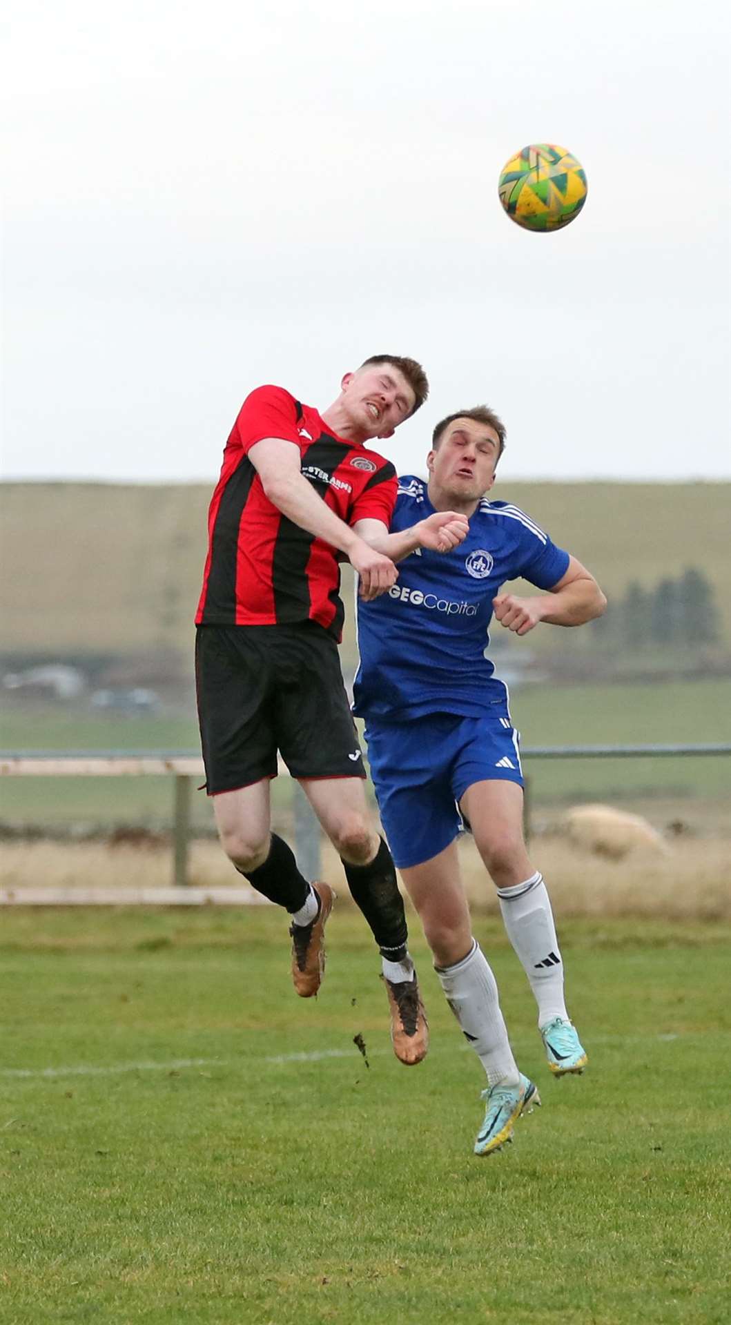 Aaron McNicol in an aerial duel with Invergordon's Cameron Mackintosh. Picture: James Gunn