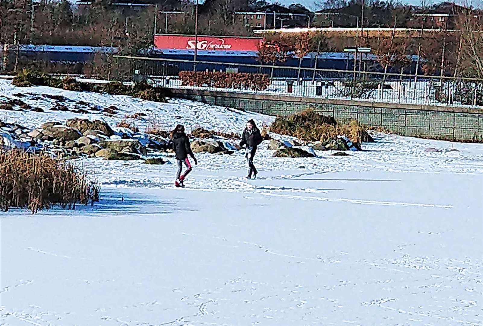 These teens were seen walking on ice at a lochan in Inverness today. Picture: Inverness Courier