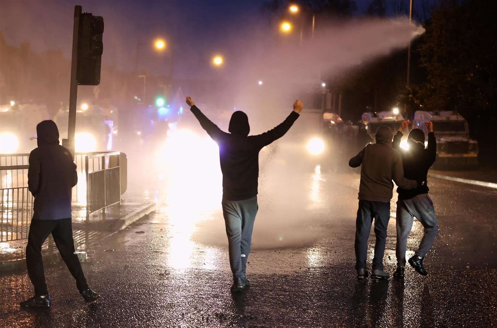 The PSNI use a water cannon on youths on the Springfield road, during further unrest in Belfast (Liam McBurney/PA)