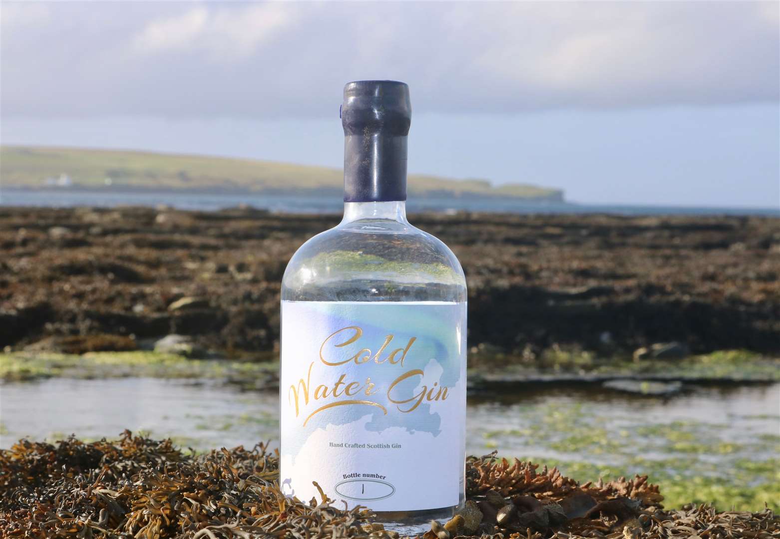 A bottle of Cold Water Gin at Thurso East, a location known for its cold water surf.
