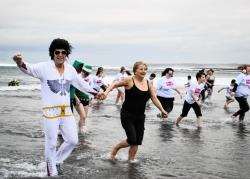 Walter Duff, aka Elvis Presley, with his wife, Valerie were among those to take part in the Boxing Day challenge for charity. Photo: John Macrae.
